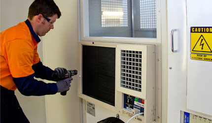 ICS employee installing L600P Air Conditioner